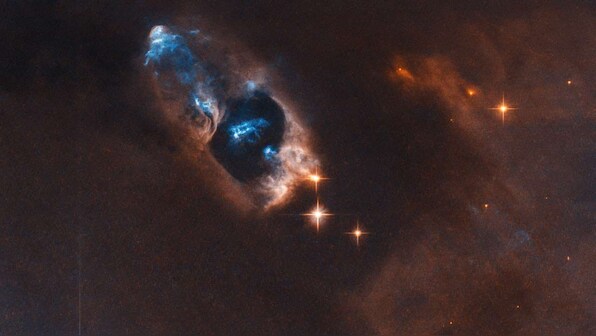 NASA's Hubble captures haunting glimpse of bright blue cluster of objects in space