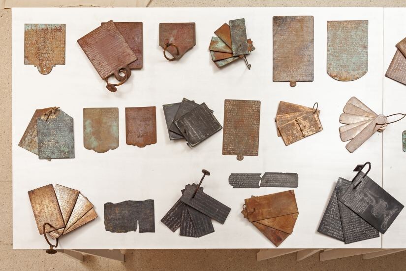 Transcripts. A set of 100 copper plate sculptures based on ancient grants. Lost scripts handwritten and etched by the artist with patination, 2018. Each one a unique piece.