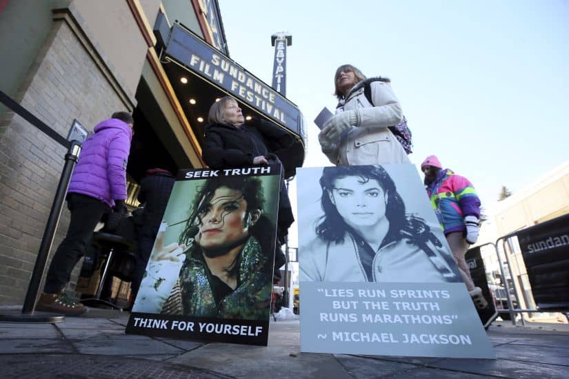 Brenda Jenkyns, left, and Catherine Van Tighem who drove from Calgary, Canada stand with signs outside of the premiere of the 