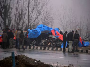 Soldiers inspect the bus after the terror attack at Pulwama. Reuters