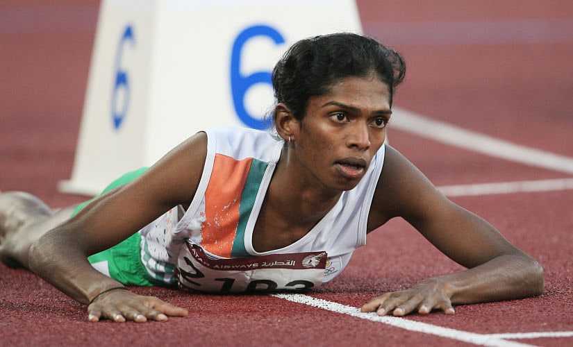 In this file picture taken December 9, 2006, India's Santhi Soundarajan lies on the track after edging out Kazakhstan's Viktoriya Yalovtseva for second place in the women's 800m final on the second day of the athletics competition for the 15th Asian Games at Khalifa Stadium in Doha. Indian athlete Santhi Soundarajan, who was stripped of her Asian Games silver medal for what was branded a failed gender test, hopes South African Caster Semenya will not suffer the same fate. AFP PHOTO/MARWAN NAAMANI/FILES (Photo by MARWAN NAAMANI / AFP FILES / AFP)