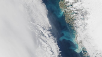 Greenland's snow-laden hills are slowly giving way to sand-covered beaches