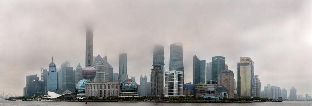 Shanghai skyscrapers disappear into the smog. Grigvovan / shutterstock