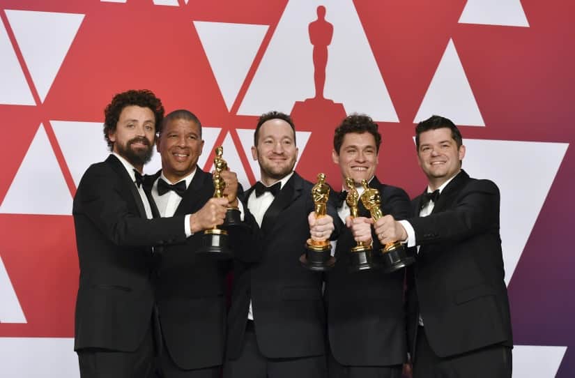 Bob Persichetti, Peter Ramsey, Rodney Rothman, Phil Lord and Christopher Miller pose with the award for best animated feature film for 