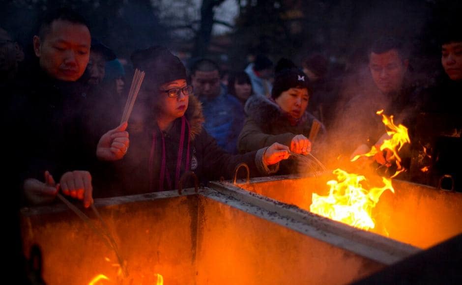 Hundreds lined up outside famous temples to burn the first joss sticks of the year, expecting it to bring them good luck. AP Hundreds lined up outside famous temples to burn the first joss sticks of the year, expecting it to bring them good luck. AP