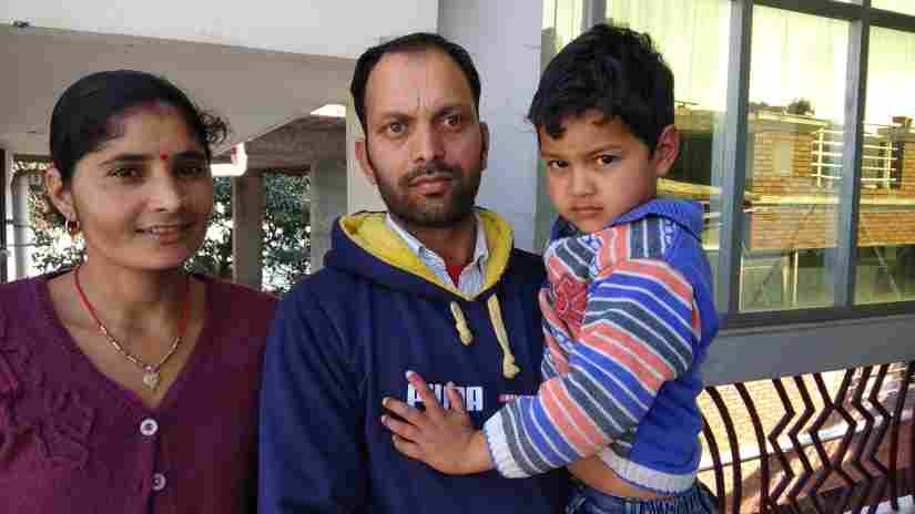 Manveer and wife Santoshi pose with their son, outside their Dehradun room. Varsha Singh