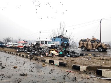 Security and Indian Army personnel around the blast site in Kashmir's Pulwama. Reuters