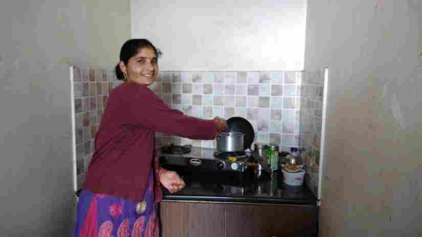 Santoshi works in her small kitchen with a smile on her face, thankful that she does not have to fetch water everyday. Varsha Singh