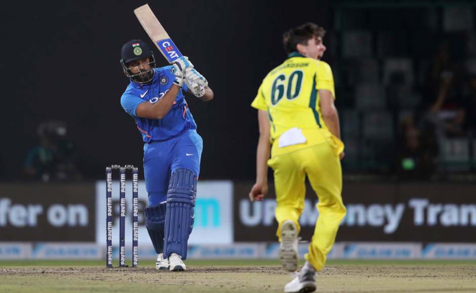 India's Rohit Sharma plays a shot as Australia's Jhye Richardson looks on during the final one day international cricket match between India and Australia in New Delhi, India, Wednesday, March 13, 2019. (AP Photo/Altaf Qadri)