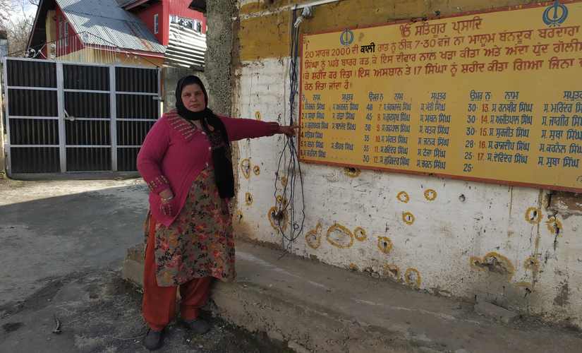 A widow points at the name of her husband killed in the Chittisinghpura massacre. Image courtesy: Aamir Ali Bhat