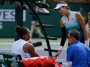 Garbine Muguruza, , speaks with Serena Williams during their match at the Indian Wells tennis tournament. AP