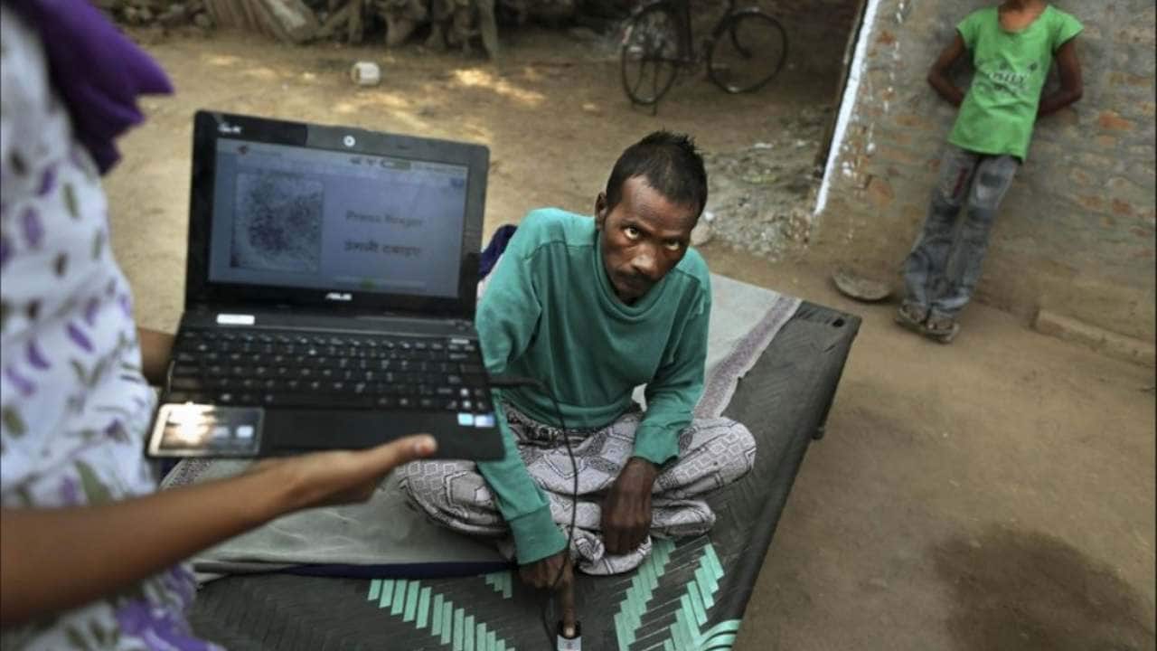 A 36-year-old Tuberculosis patient Kallu, who also suffers from HIV, gives his fingerprint as part of a verification program to Operation ASHA program counselor Shammo Khan. AP