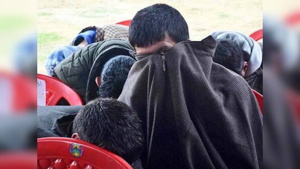 Afraid of social boycott, BJP workers hide their faces at Kashmir rally; despite recent gains, backing saffron party still a taboo in Valley