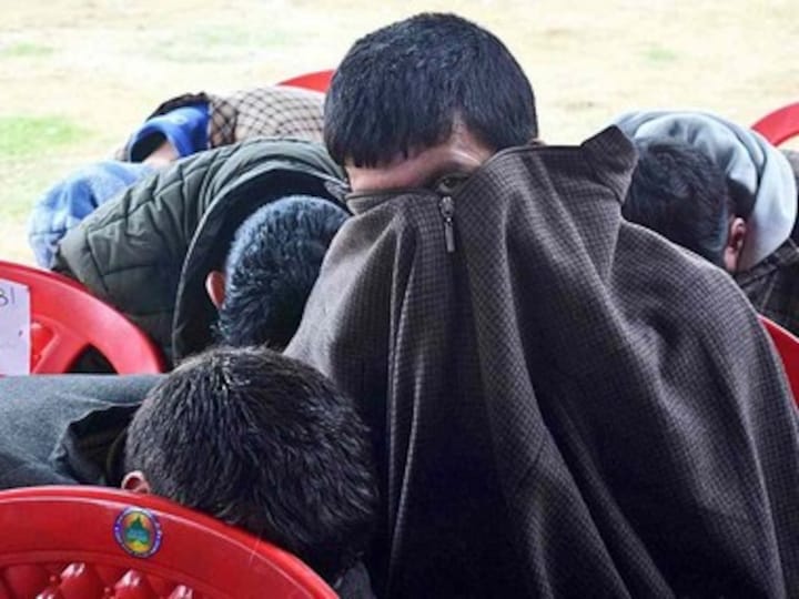 Afraid of social boycott, BJP workers hide their faces at Kashmir rally; despite recent gains, backing saffron party still a taboo in Valley
