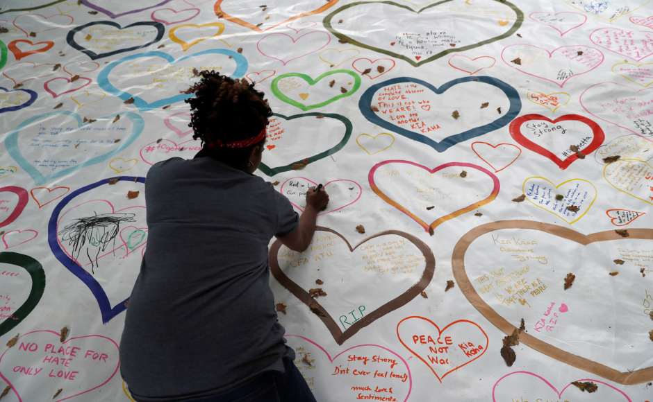 In Christchurch, flowers, signs and candles were placed near a police line outside the Masjid Al Noor. Reuters In Christchurch, flowers, signs and candles were placed near a police line outside the Masjid Al Noor. Reuters