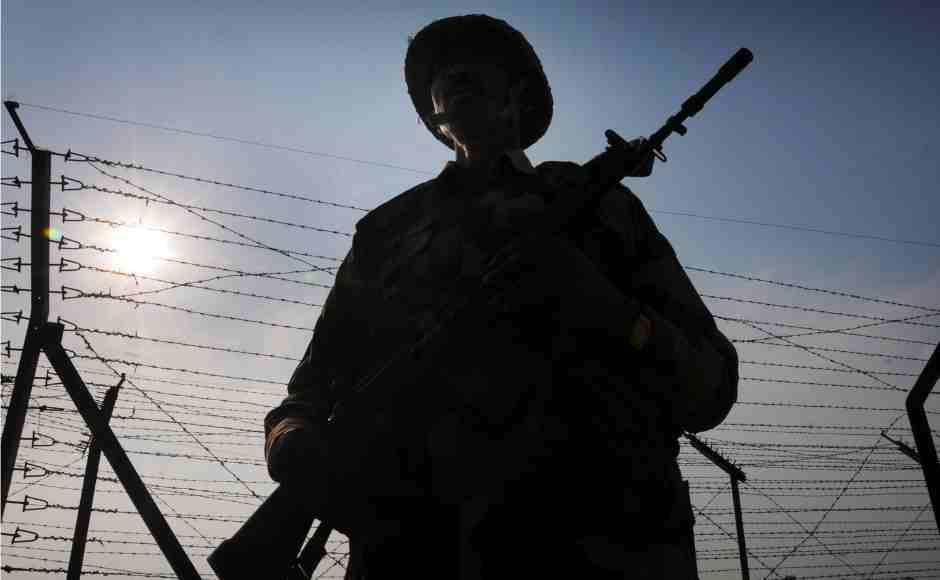 Border Security Force personnel stand guard along the international border at Attari near Amritsar as security beefs up amid escalating tension between India and Pakistan. PTI Border Security Force personnel stand guard along the international border at Attari near Amritsar as security beefs up amid escalating tension between India and Pakistan. PTI