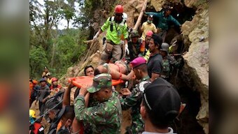 Eight killed in Indonesia gold mine collapse; rescue teams deploy excavator to search for three dozen still feared trapped