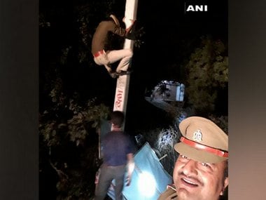 Uttar Pradesh cop clicks selfie while constable climbs electric pole to remove political banner, probe ordered