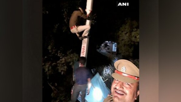 Uttar Pradesh cop clicks selfie while constable climbs electric pole to remove political banner, probe ordered