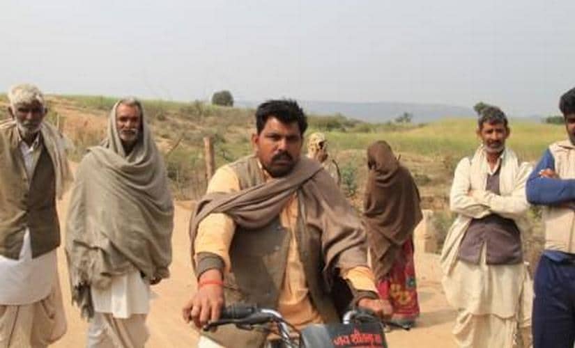 Uday Singh Gurjar patrolls his fields on a motorcycle o watch out for stray cattle attack