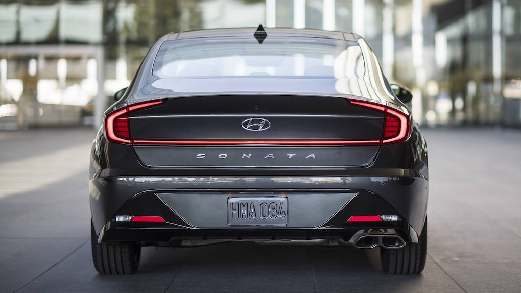 At the rear, a wide horizontal line extends across the center of the trunk, stretching to the edges of the car. This line is actually a long LED strip that connects each brake light.