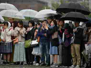 People gather outside the Imperial Palace. AFP