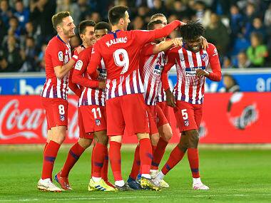 Atletico Madrid’s Thomas celebrates with teammates after scoring against Deportivo Alaves. AFP