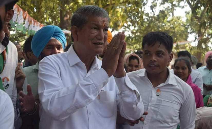 Congress leader Harish Rawat greets supporters after casting his votes. Rahul Singh Shekhawat /101Reporters