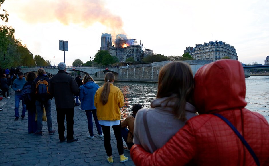 Distraught Parisians and stunned tourists gazed in disbelief as the inferno raged at the cathedral, which sits on the Ile de la Cite, an island in the River Seine and marks the very centre of Paris. AP Distraught Parisians and stunned tourists gazed in disbelief as the inferno raged at the cathedral, which sits on the Ile de la Cite, an island in the River Seine and marks the very centre of Paris. AP