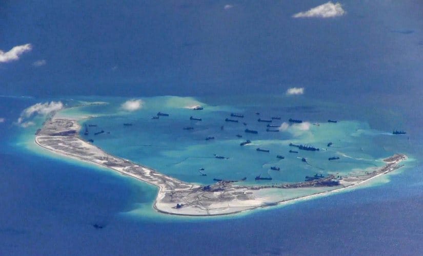 his still image, from video taken by an American P-8A Poseidon surveillance aircraft in 2015, purportedly shows Chinese dredging vessels around Mischief Reef in the disputed Spratly Islands in the South China Sea. US Navy/Handout via Reuters