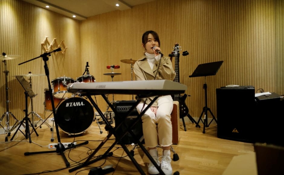 Miyu Takeuchi, a trainee with the K-pop agency Mystic Entertainment, sings during a training session in Seoul. Takeuchi said it wasn't a difficult decision to leave a 10-year career with a top idol band <em>AKB48</em> back home in Japan to sign with the K-pop agency Mystic Entertainment in March as a trainee. Even with her experience, she has seven hours of vocal training a day and two-hour dance lessons twice a week, plus early morning Korean lessons. She is not allowed to have a boyfriend but she says she has no regrets, despite the fact there is no guarantee she will make it. Reuters/Kim Hong-Ji. Miyu Takeuchi, a trainee with the K-pop agency Mystic Entertainment, sings during a training session in Seoul. Takeuchi said it wasn't a difficult decision to leave a 10-year career with a top idol band <em>AKB48</em> back home in Japan to sign with the K-pop agency Mystic Entertainment in March as a trainee. Even with her experience, she has seven hours of vocal training a day and two-hour dance lessons twice a week, plus early morning Korean lessons. She is not allowed to have a boyfriend but she says she has no regrets, despite the fact there is no guarantee she will make it. Reuters/Kim Hong-Ji.