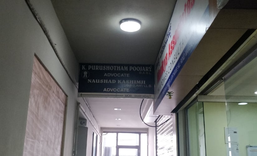 The board outside Puroshottom Poojary's office still has the name of Naushad. Image by Greeshma Kuthar
