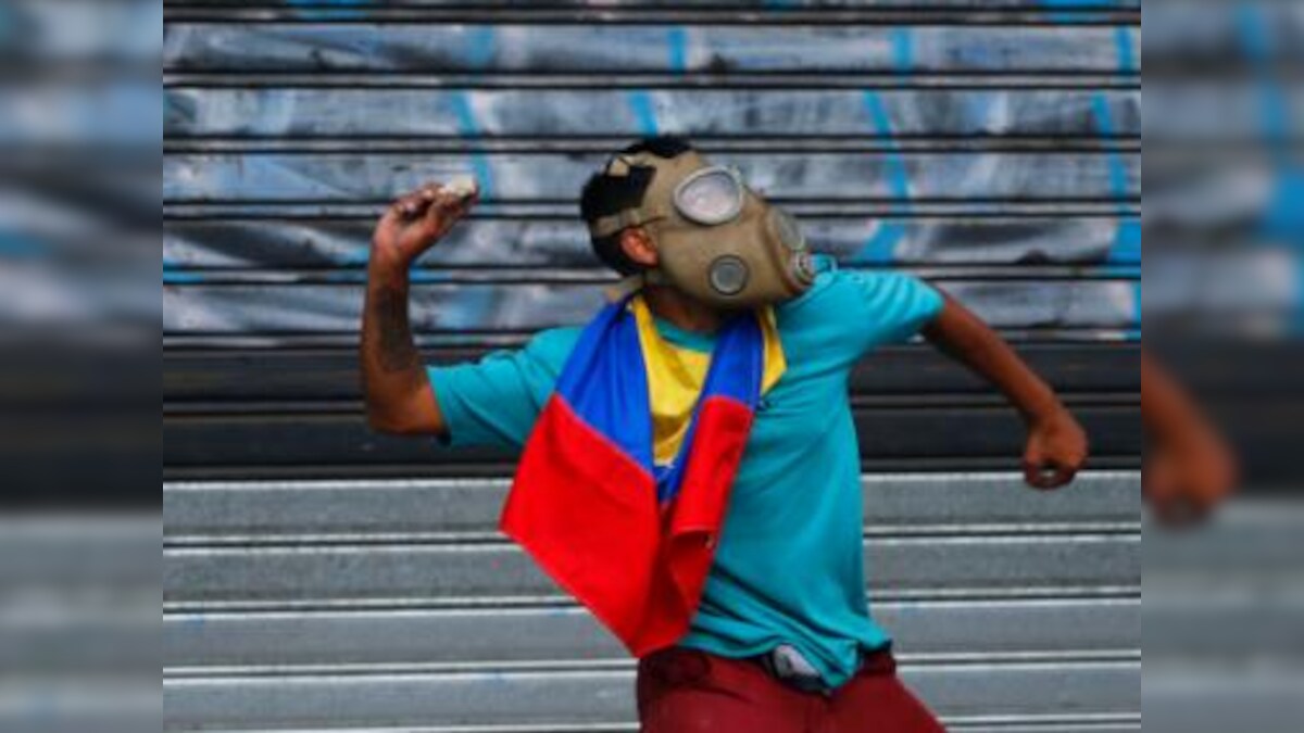 Venezuela protests: 27-year-old woman dies in rioting; 24 injured in May Day clashes between Juan Guaido supporters and military forces