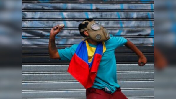 Venezuela protests: 27-year-old woman dies in rioting; 24 injured in May Day clashes between Juan Guaido supporters and military forces