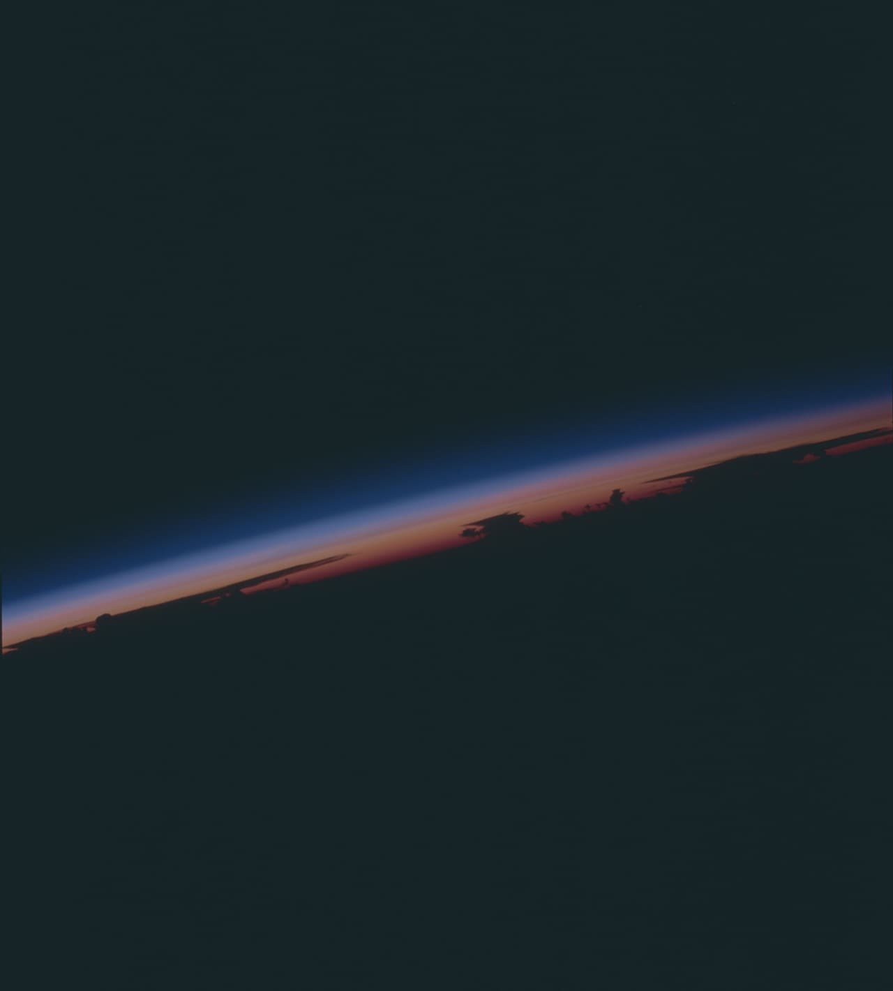 Space Shuttle photograph of the Earth over South America taken on August 8, 1991, showing double layer of Pinatubo aerosol cloud (dark streaks) above cloud tops. Image credit: NASA Observatory