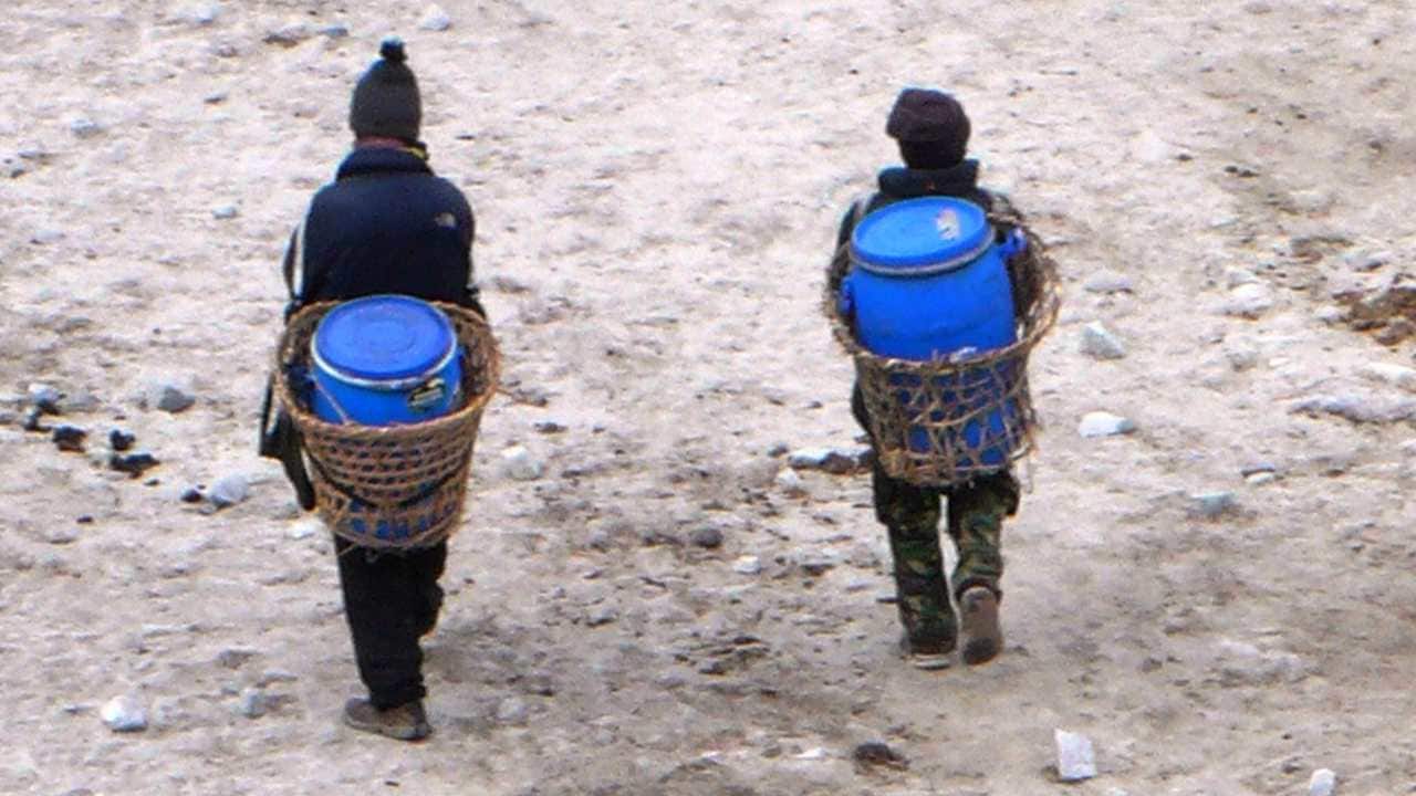 Porters carrying the waste. Image credit: SummitClimb