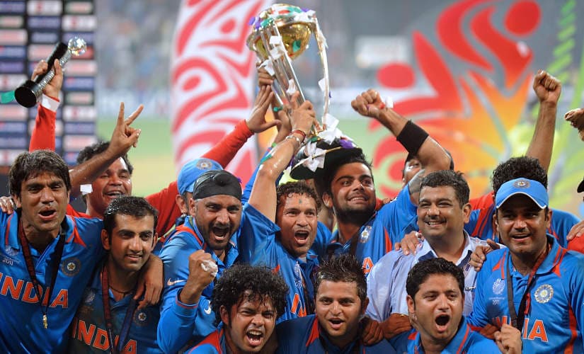 Indian cricketers pose with the trophy as they celebrate after beating Sri Lanka in the ICC Cricket World Cup 2011 final match at The Wankhede Stadium in Mumbai on April 2, 2011. India defeated Sri Lanka by six wickets on Saturday to win the 2011 World Cup. AFP PHOTO/MANAN VATSYAYANA (Photo by MANAN VATSYAYANA / AFP)