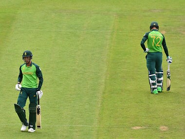South Africa’s Dwaine Pretorius (L) leaves the field after losing his wicket for 0ne as South Africa’s Rassie van der Dussen looks on during the 2019 Cricket World Cup group stage match between England and South Africa at The Oval in London on May 30, 2019. (Photo by Glyn KIRK / AFP) / RESTRICTED TO EDITORIAL USE
