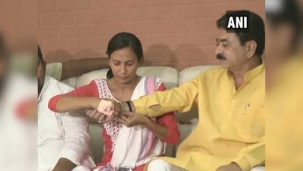 BJP MLA says woman NCP leader he kicked, punched on streets is 'like my sister'; victim ties him rakhi