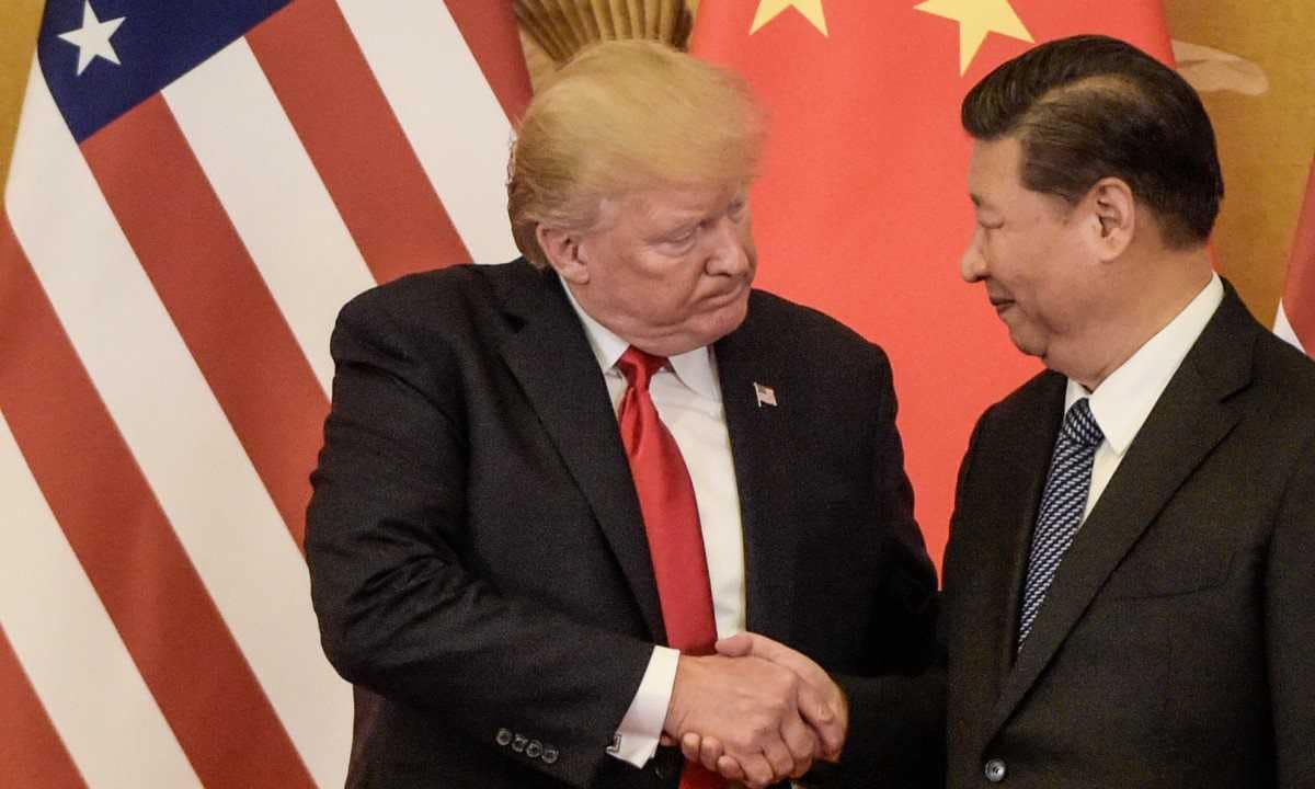 US President Donald Trump shakes hand with China's President Xi Jinping at the end of a press conference at the Great Hall of the People in Beijing in November 2017. AFP
