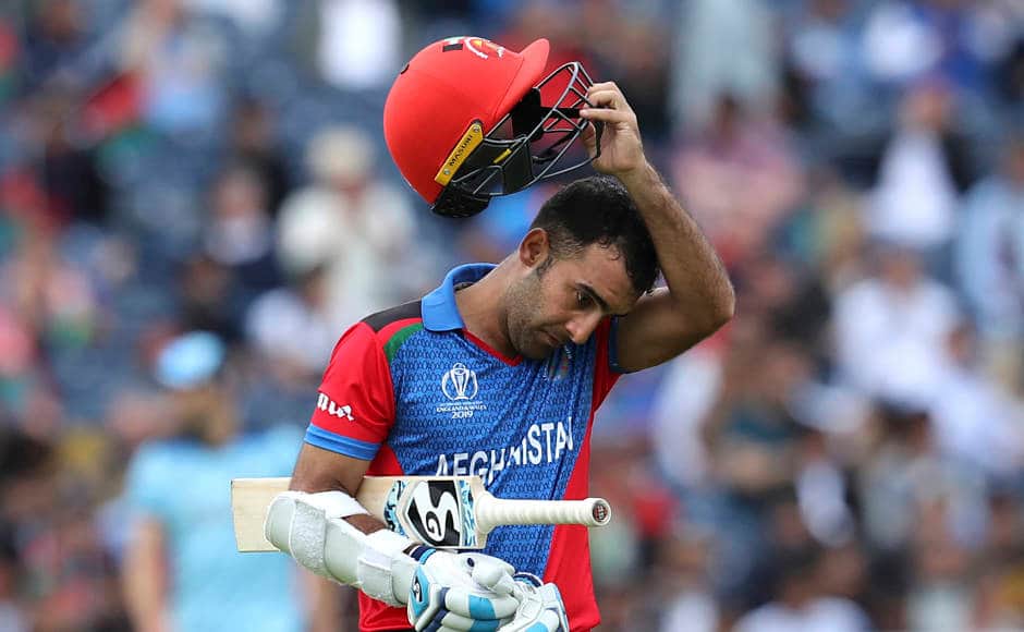 A disappointed Hashmatullah Shahidi walks back to the pavilion after being dismissed. AP 