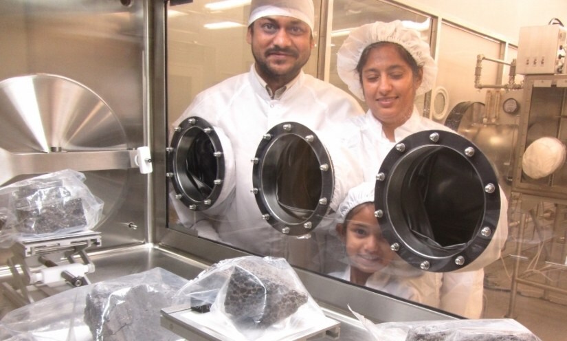 Kuljeet, Ritesh and their daughter, Esha, stand next to an exhibit of the moon rocks which came back with the Apollo 15 and Apollo 16 mission to the Moon in 1970s, at the Lunar repository of Jonson space centre (2015).