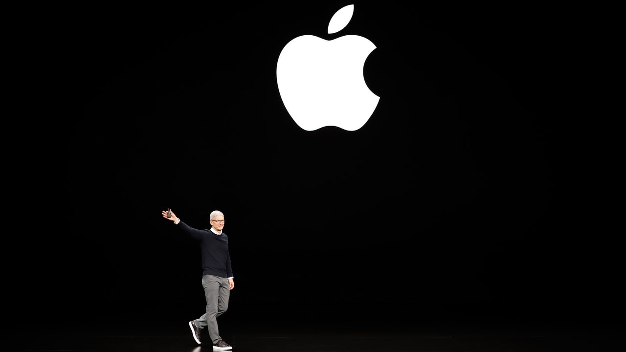 Tim Cook, CEO of Apple, waves to attendees during an Apple special event. Reuters