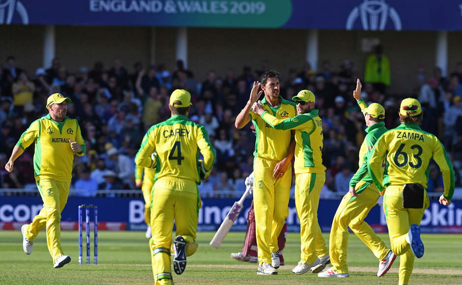 Australian fielders run to celebrate with Australia's Mitchell Starc (C) after he takes the wicket of West Indies' captain Jason Holder during the 2019 Cricket World Cup group stage match between Australia and West Indies at Trent Bridge in Nottingham, central England, on June 6, 2019. (Photo by Paul ELLIS / AFP) / RESTRICTED TO EDITORIAL USE