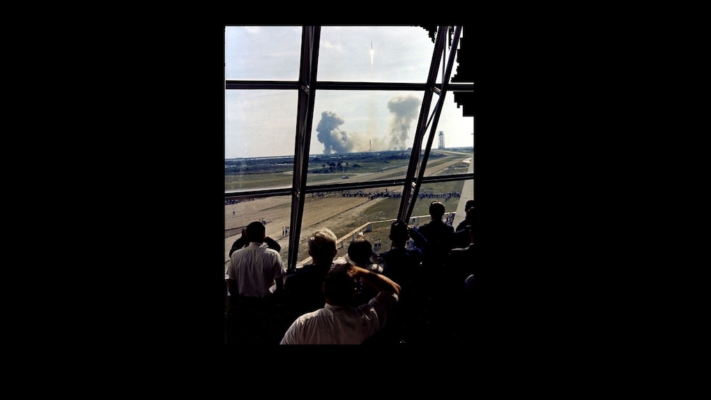 The crew looking at the Saturn V rocket rising above at about 10 times its own length. Source: ALSJ/NASA