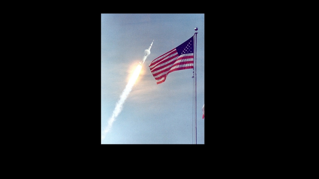 The Saturn V rocket passes the U.S. flag carrying the first human beings to space. Source: ALSJ/NASA