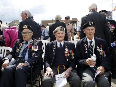 British D-Day veteran Cyril Banks, center, sits with two fellow veterans during an event to mark the 75th anniversary of D-Day in Arromanches, Normandy, France. AP
