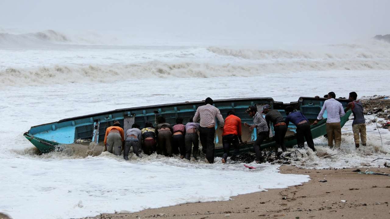 Fishermen move a fishing boat to a safer place along the shore ahead of the expected landfall of Cyclone Vayu. Reuters