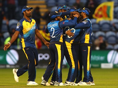 Sri Lanka's Lasith Malinga (2R) is mobbed by teammates after they he bowled out Afghanistan's Hamid Hasan for six runs to win 2019 Cricket World Cup group stage match between Afghanistan and Sri Lanka at Sophia Gardens stadium in Cardiff, south Wales, on June 4, 2019. - Sri Lanka won the match by 34 runs. (Photo by GEOFF CADDICK / AFP) / RESTRICTED TO EDITORIAL USE