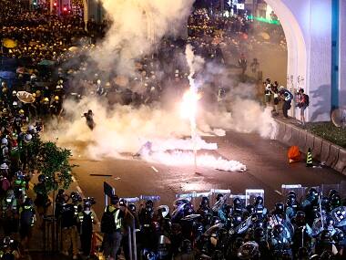 Hong Kong protests: Police fire tear gas, rubber bullets after protesters daub China's office with eggs, graffiti in rebuke to Beijing's rule